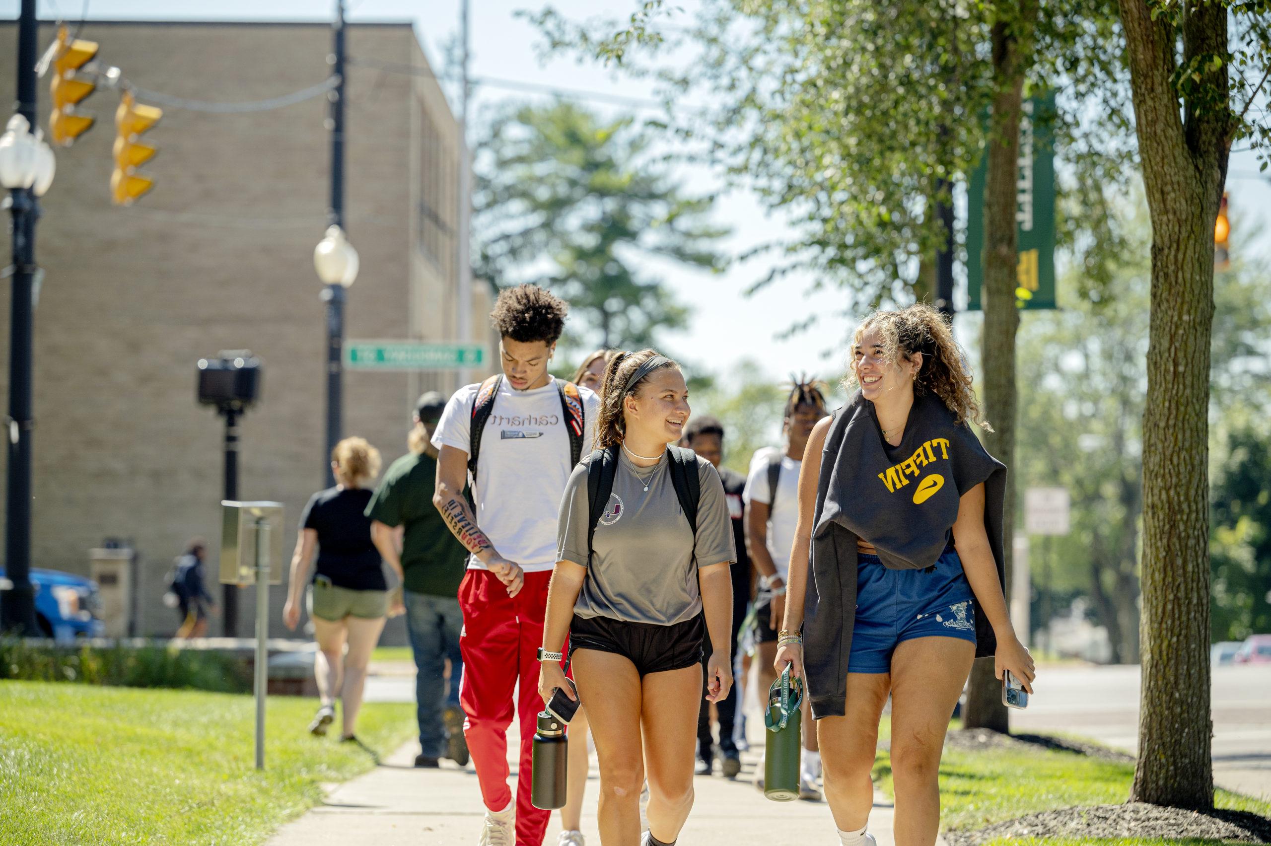 Smiling students walk to class
